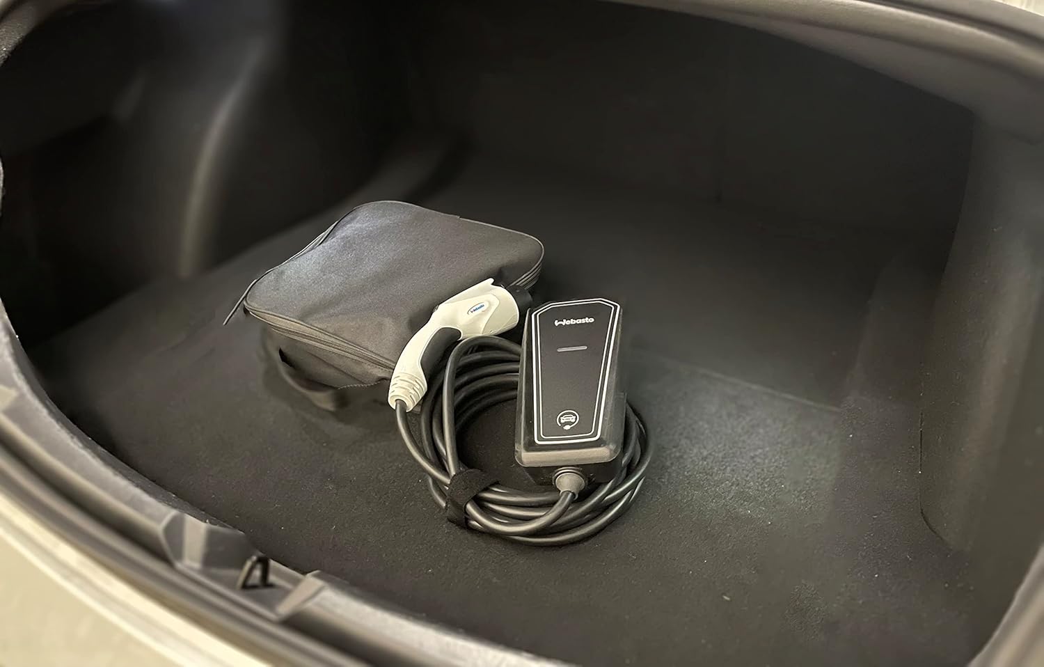 Webasto Go charger and carrying case stored in a car trunk