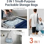 travel inspira 22L No-Pump Vacuum Bag, Roll-Up Crossbody Cube | No-pump 22L TPU vacuum cube: roll to compress, wear crossbody. IP67 waterproof. Black/Fluorescent Green/Gray Blue. Reusable.