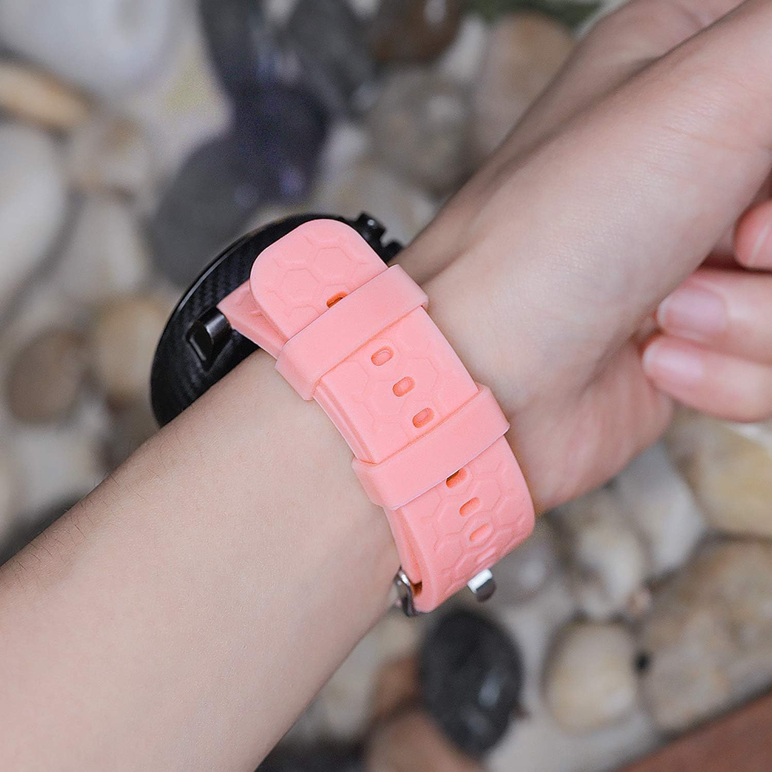 Pink FoundEast silicone smartwatch band worn on a wrist, attached to a smartwatch.