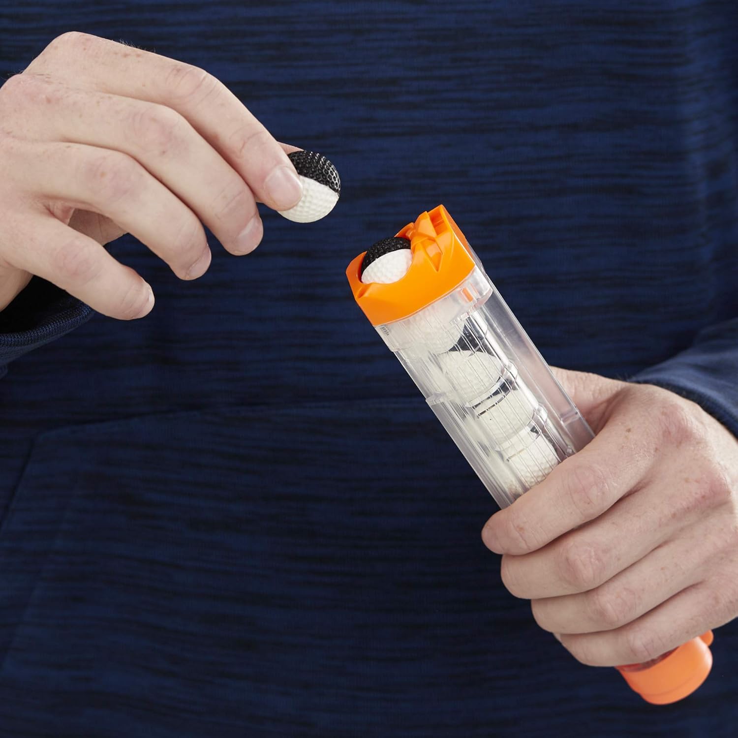 Hand loading a high-impact round into the magazine of a NERF Rival blaster