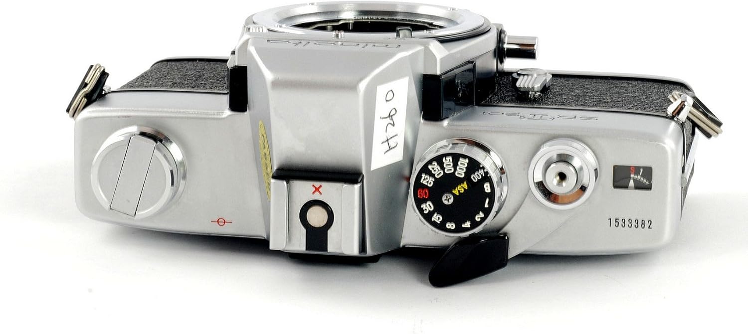 Minolta SRT-201 camera with the back open, showing the film loading area.