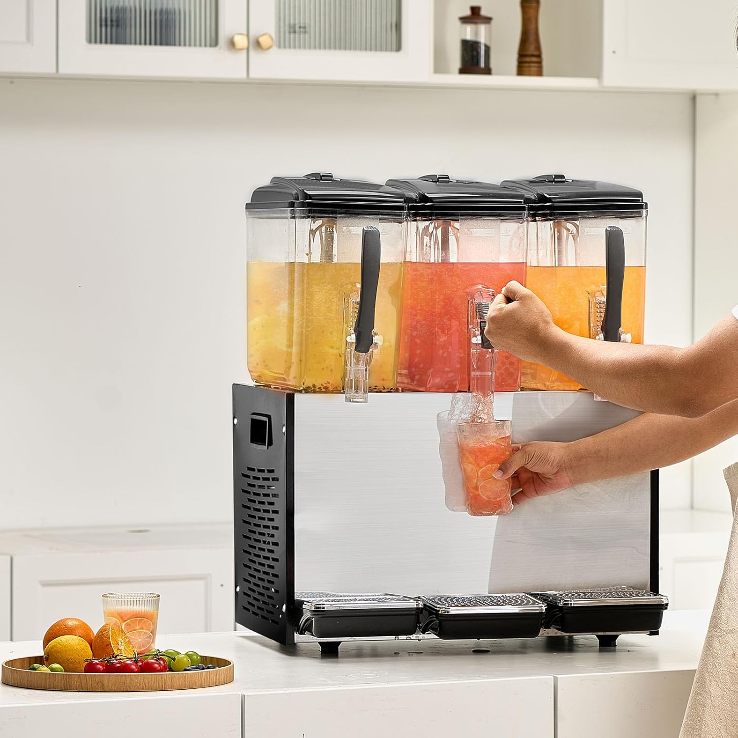 A person dispensing a beverage from one of the tanks into a glass.