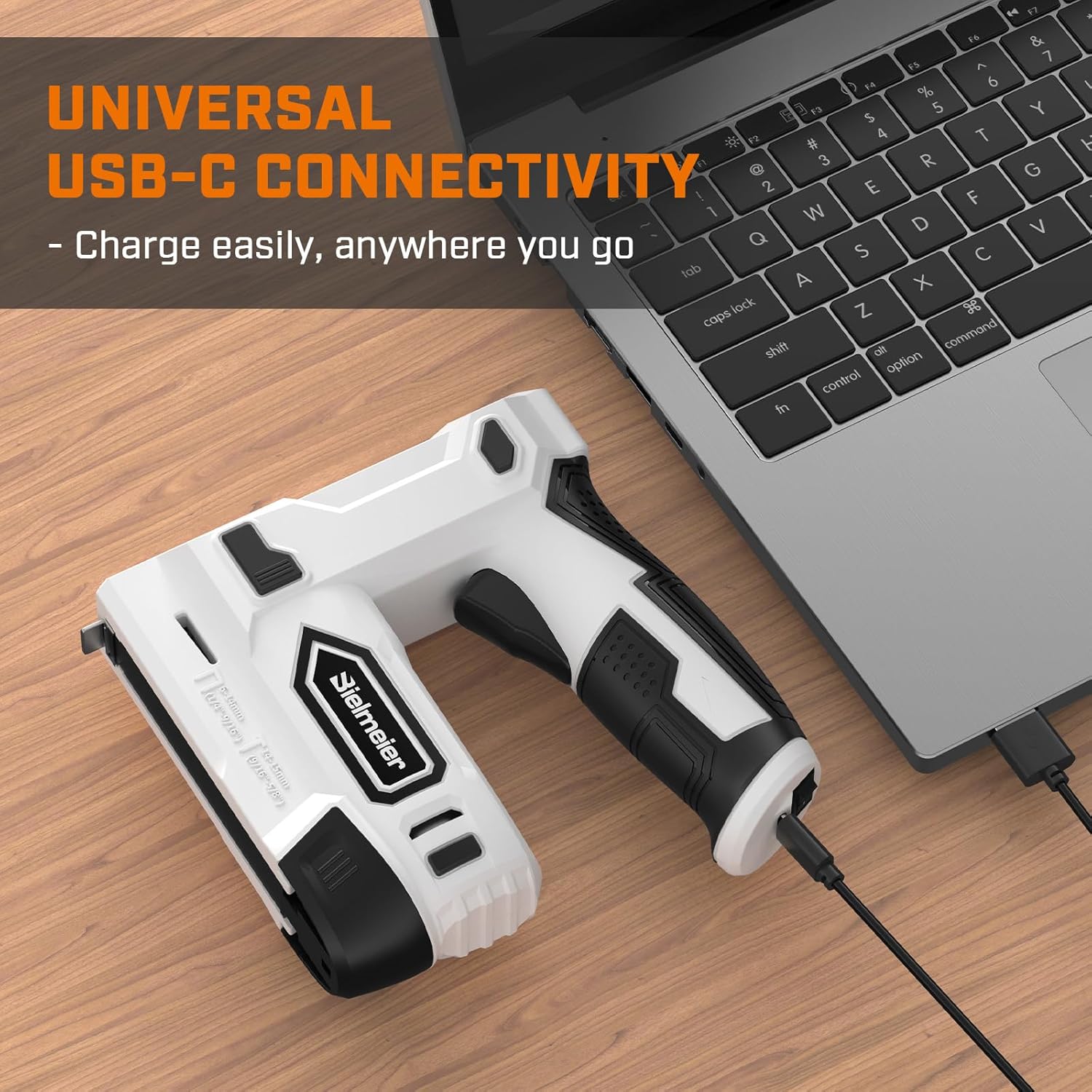 Electric staple gun connected to a laptop via USB-C for charging