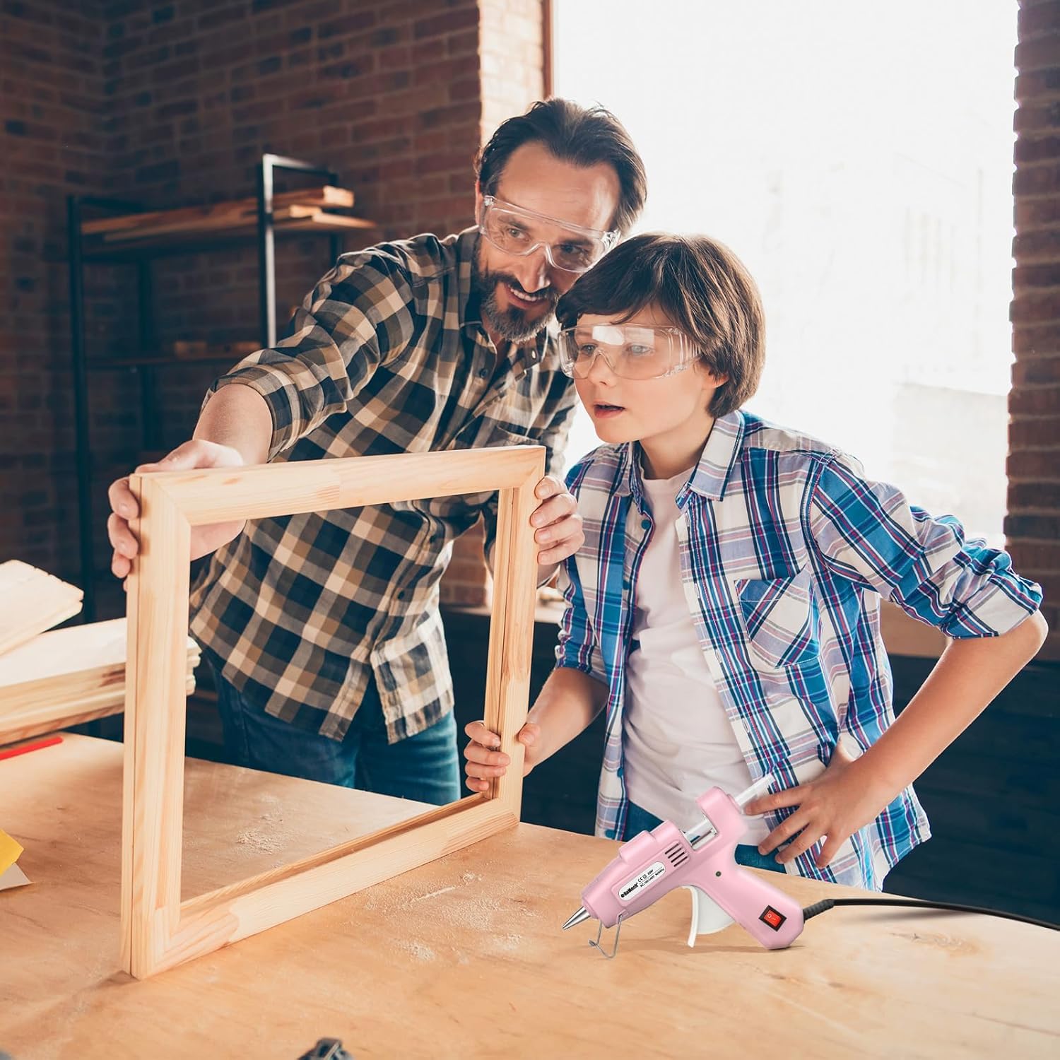 Father and son using a ROMECH Mini Hot Glue Gun for a craft project