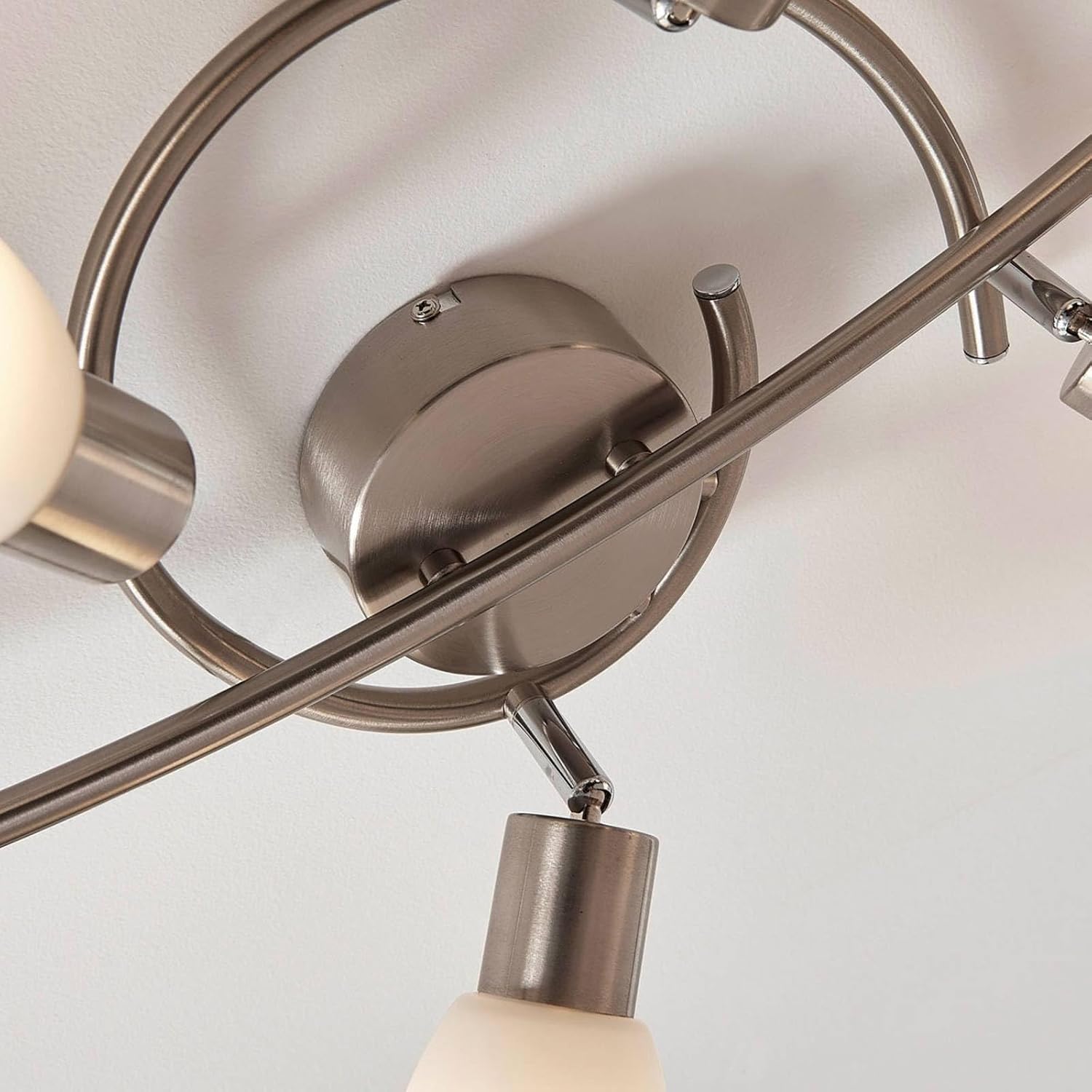 Close-up view of a single E14 spotlight on the Lindby Arda fixture, showing the frosted glass shade and the bulb inside, useful for demonstrating bulb replacement.