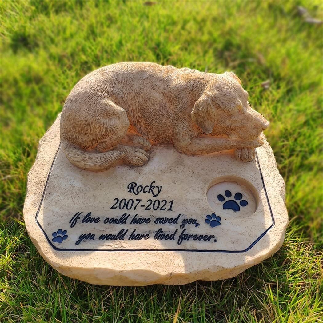 A Memorial Stone Engraved with The Name, Featuring A Sleeping Dog Inlaid At The Top.