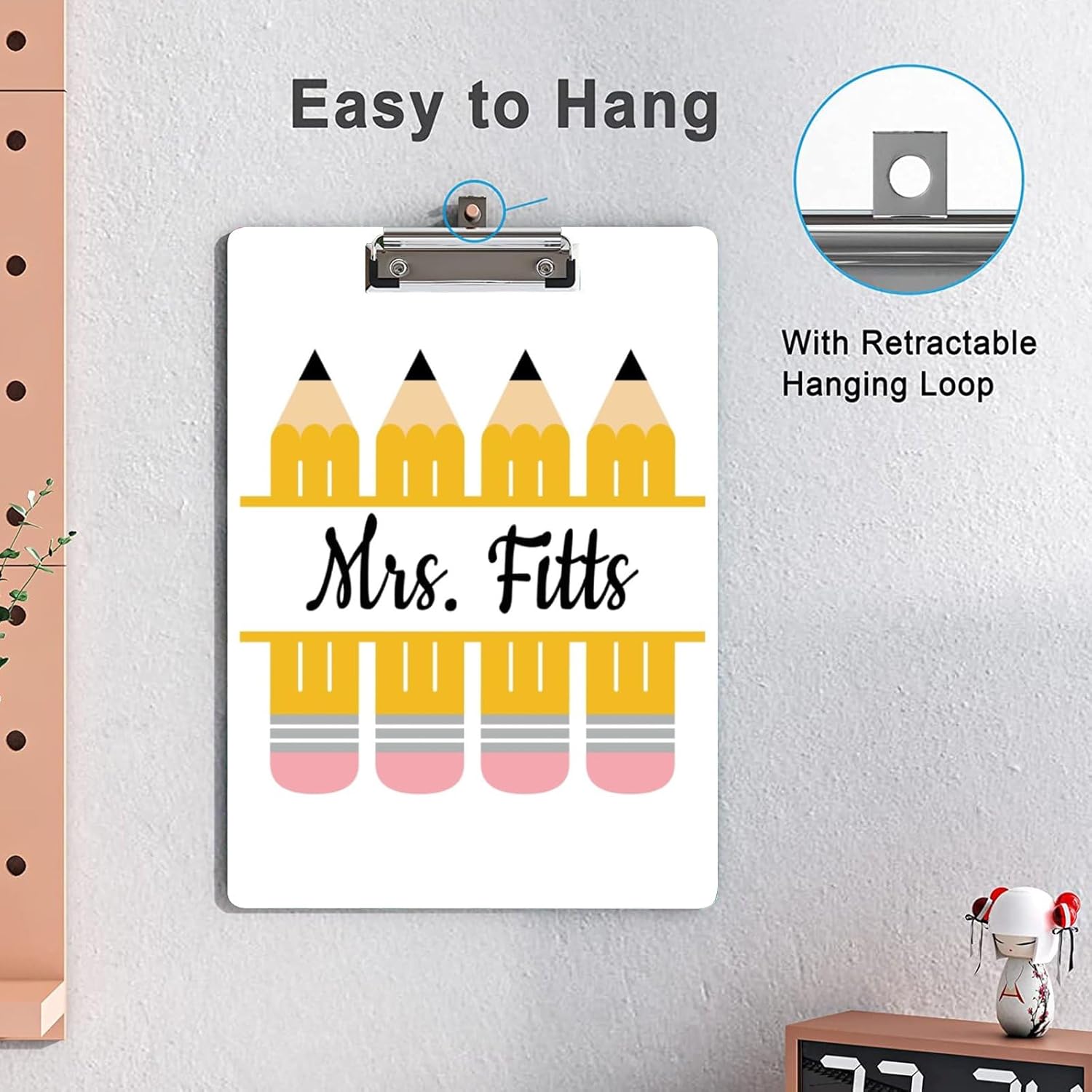 Clipboard hanging on a wall, showing the retractable loop