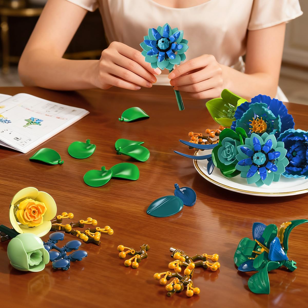 Hands assembling a flower from building blocks