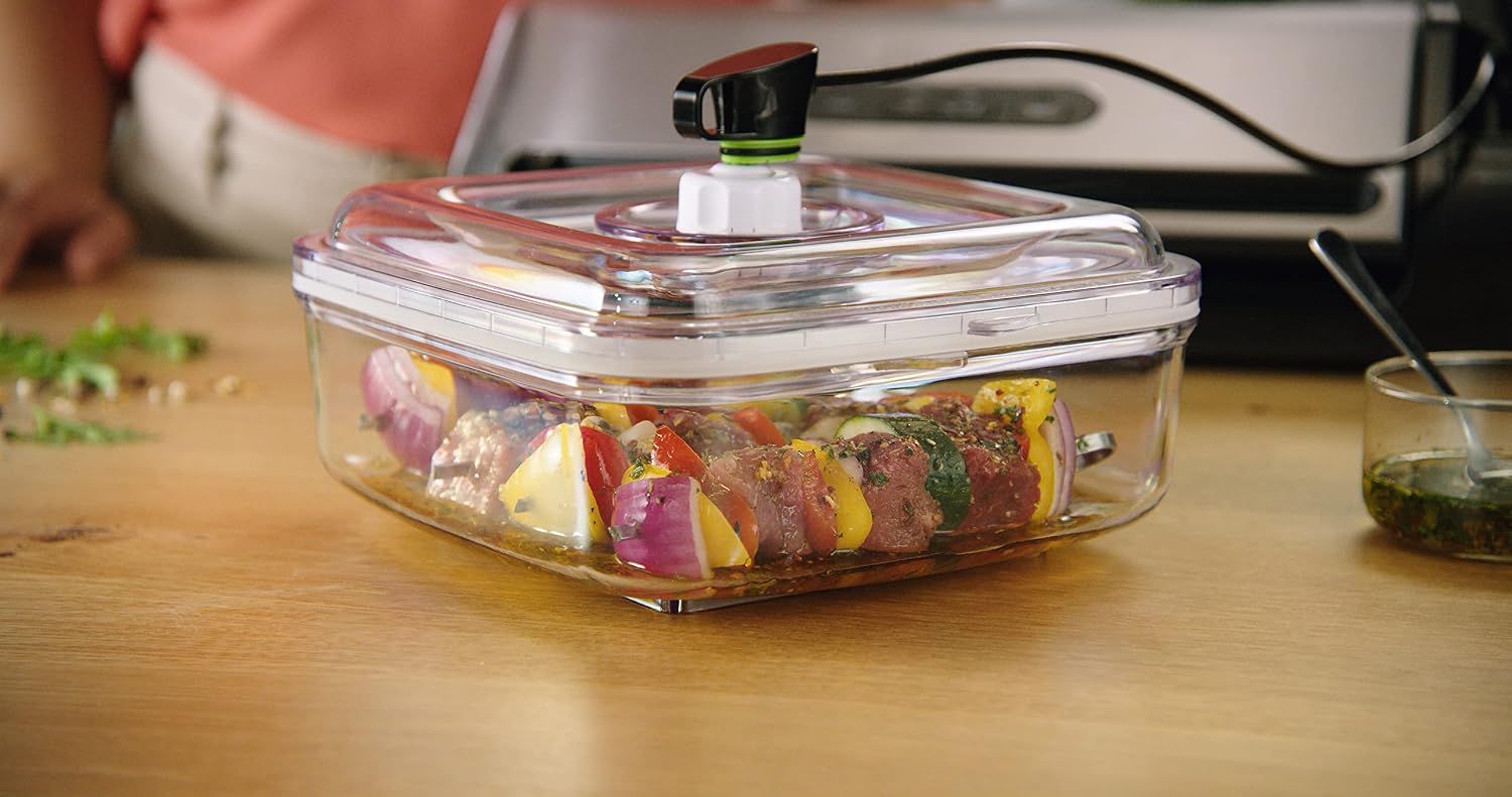 FoodSaver vacuum container with marinated food, connected to the vacuum sealer via the accessory hose.