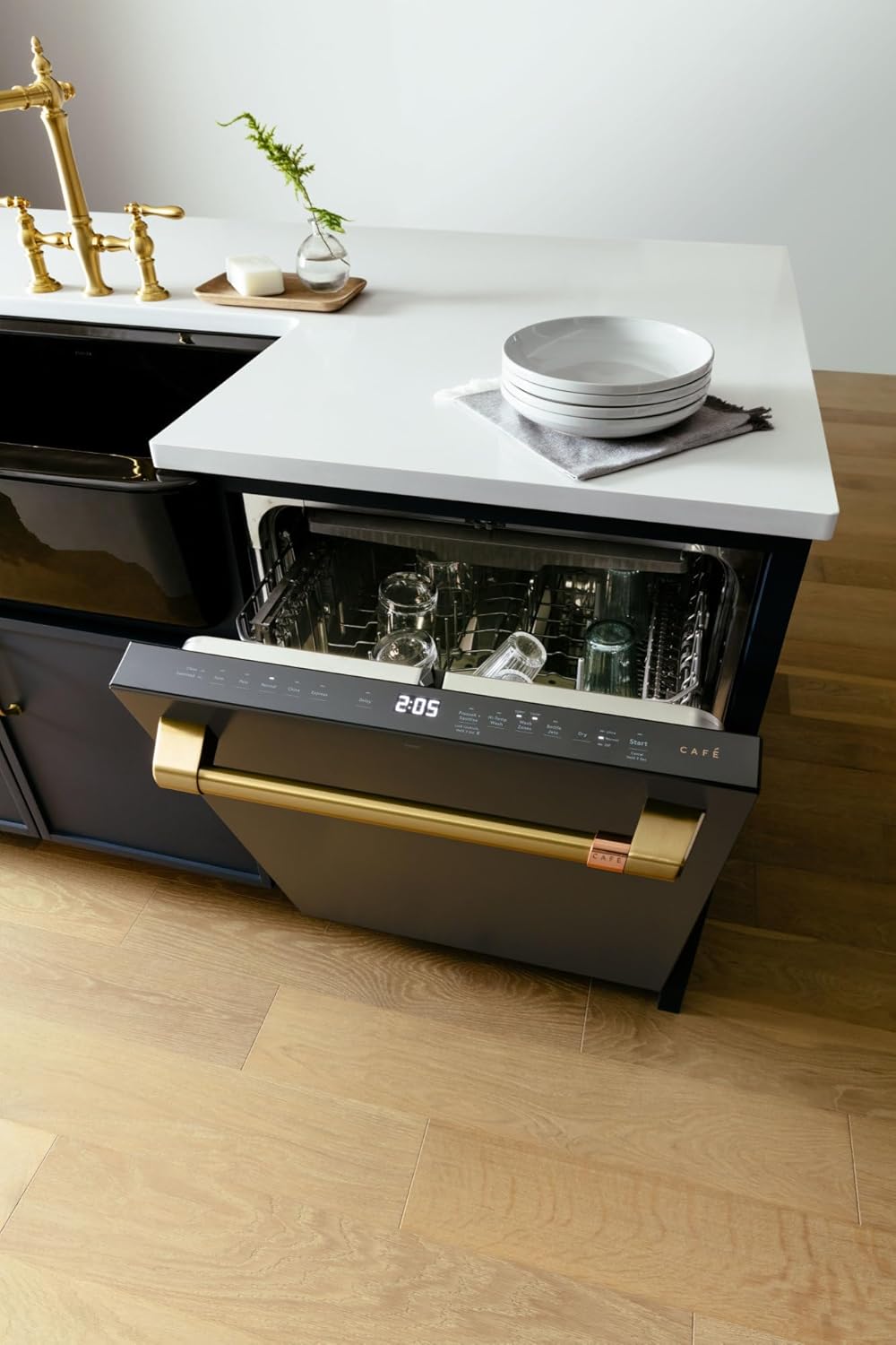 CAFE dishwasher installed in a kitchen, with the door slightly ajar revealing the interior.