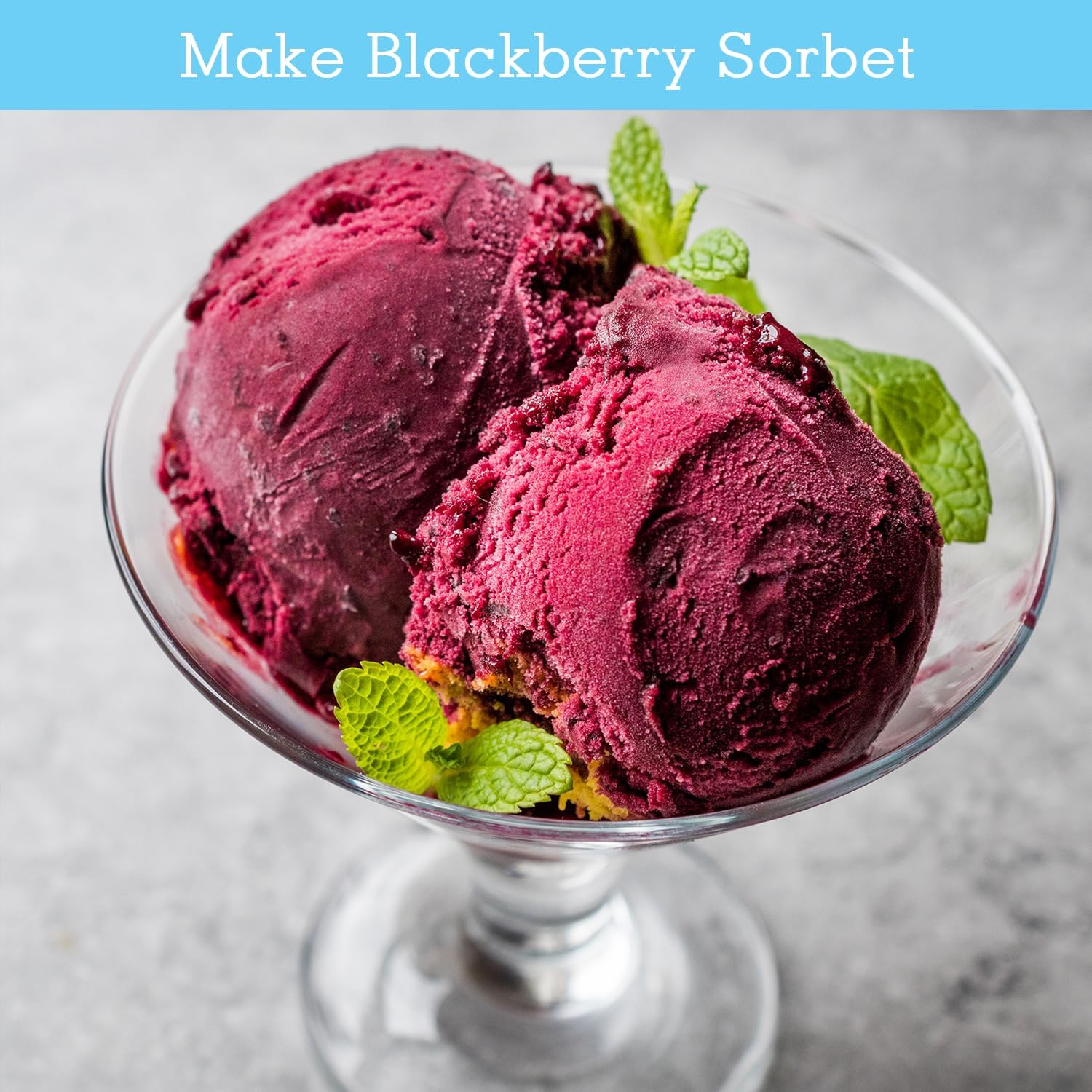 Two scoops of blackberry sorbet in a glass bowl