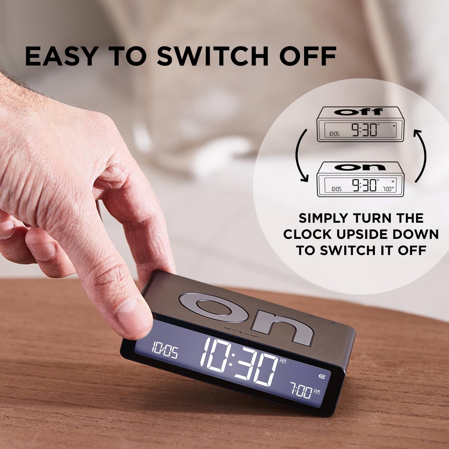 A hand flipping the Lexon LR157P4 alarm clock from 'ON' to 'OFF' to deactivate the alarm.