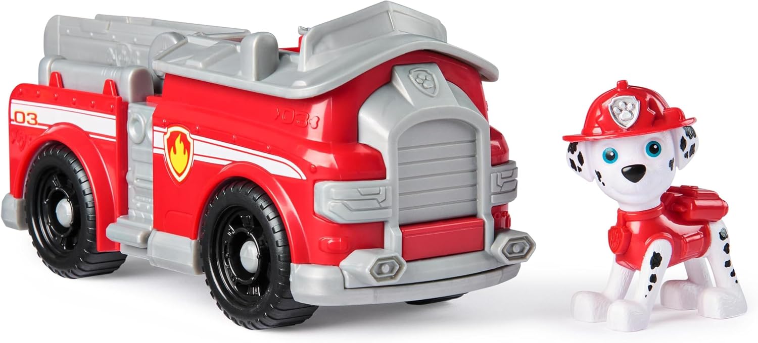 Marshall figure next to his red fire truck vehicle.