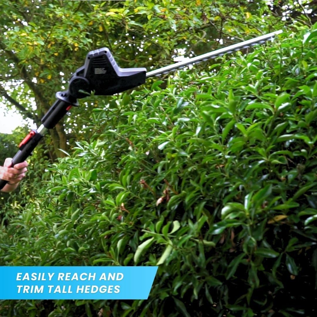 Person using the hedge trimmer attachment on a tall hedge.
