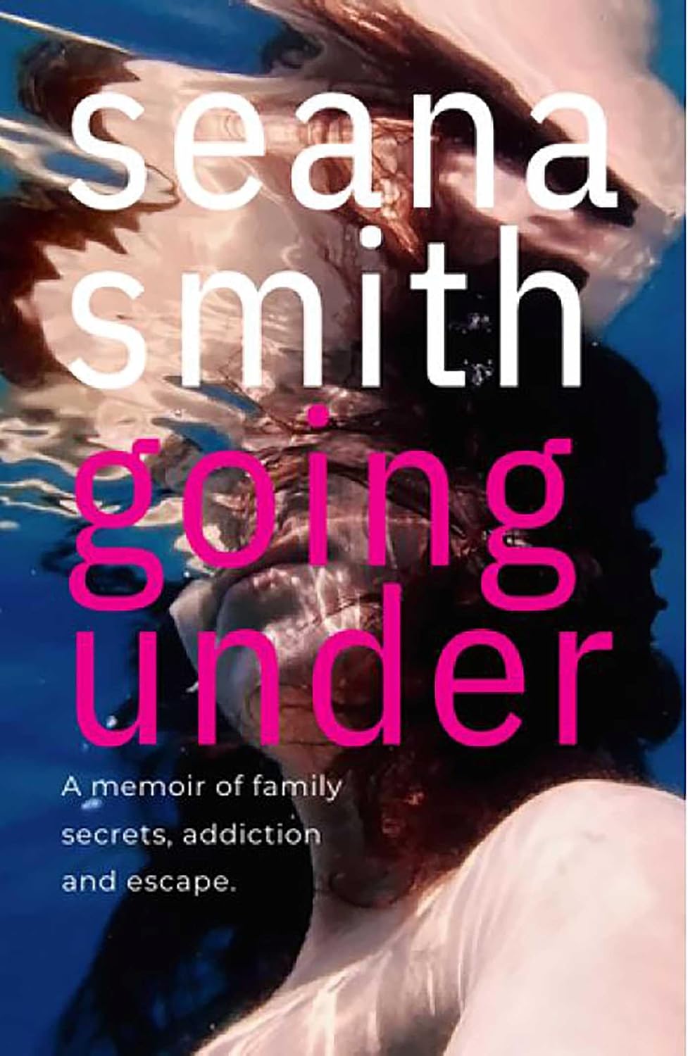 Cover for the memoir Going Under by Seana Smith. A light-skinned, dark-haired woman is shown underwater in a pool, surrounded by dark blue, her reflection visible in the water's surface.