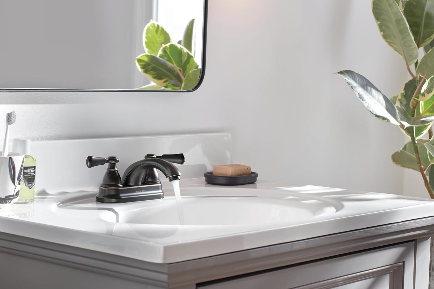 Peerless Elmhurst Faucet in use, water flowing into a sink