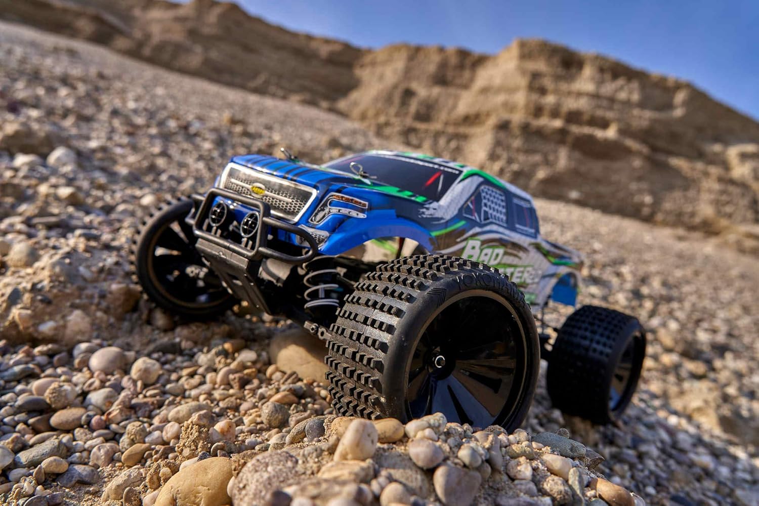 Carson Bad Buster 2.0 RC car climbing a rocky incline.