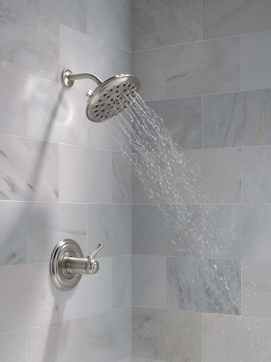 DELTA showerhead installed in a shower with water flowing