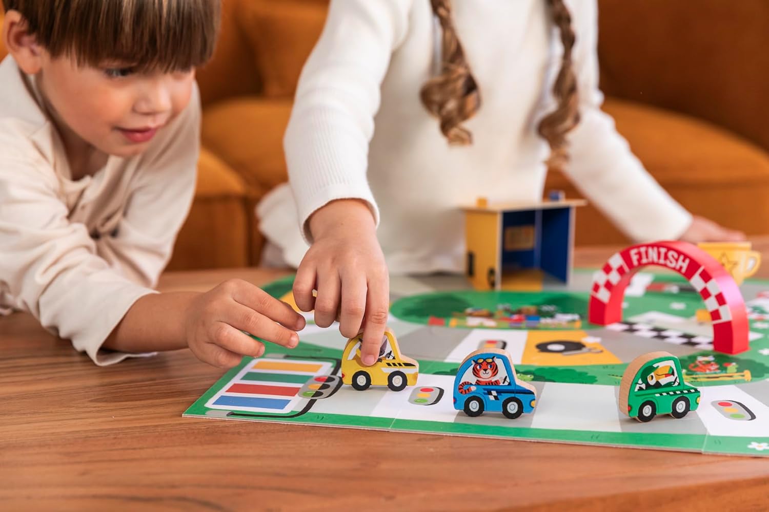 Children playing Goula First Race, moving their cars