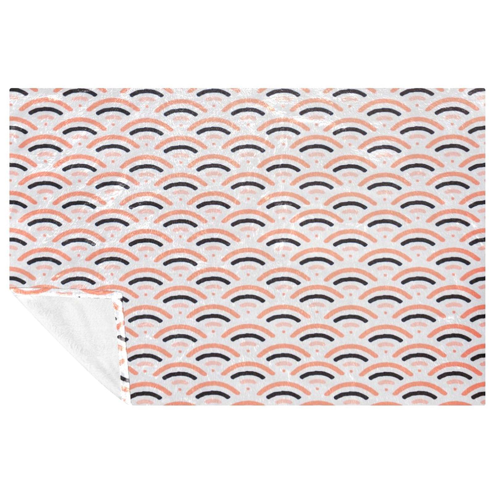 Couverture chaude motif écailles de poisson pour des moments cocooning sur le canapé