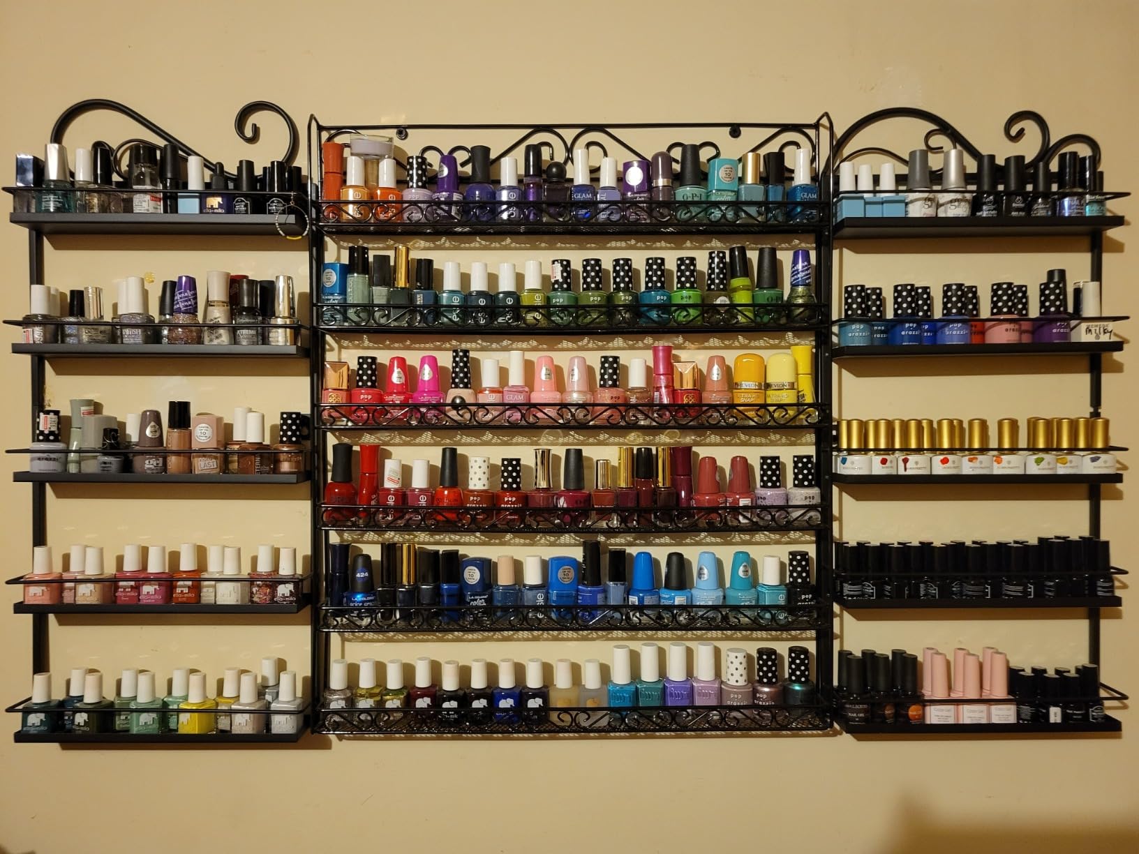 Wall-mounted nail polish rack holding rows of polish bottles