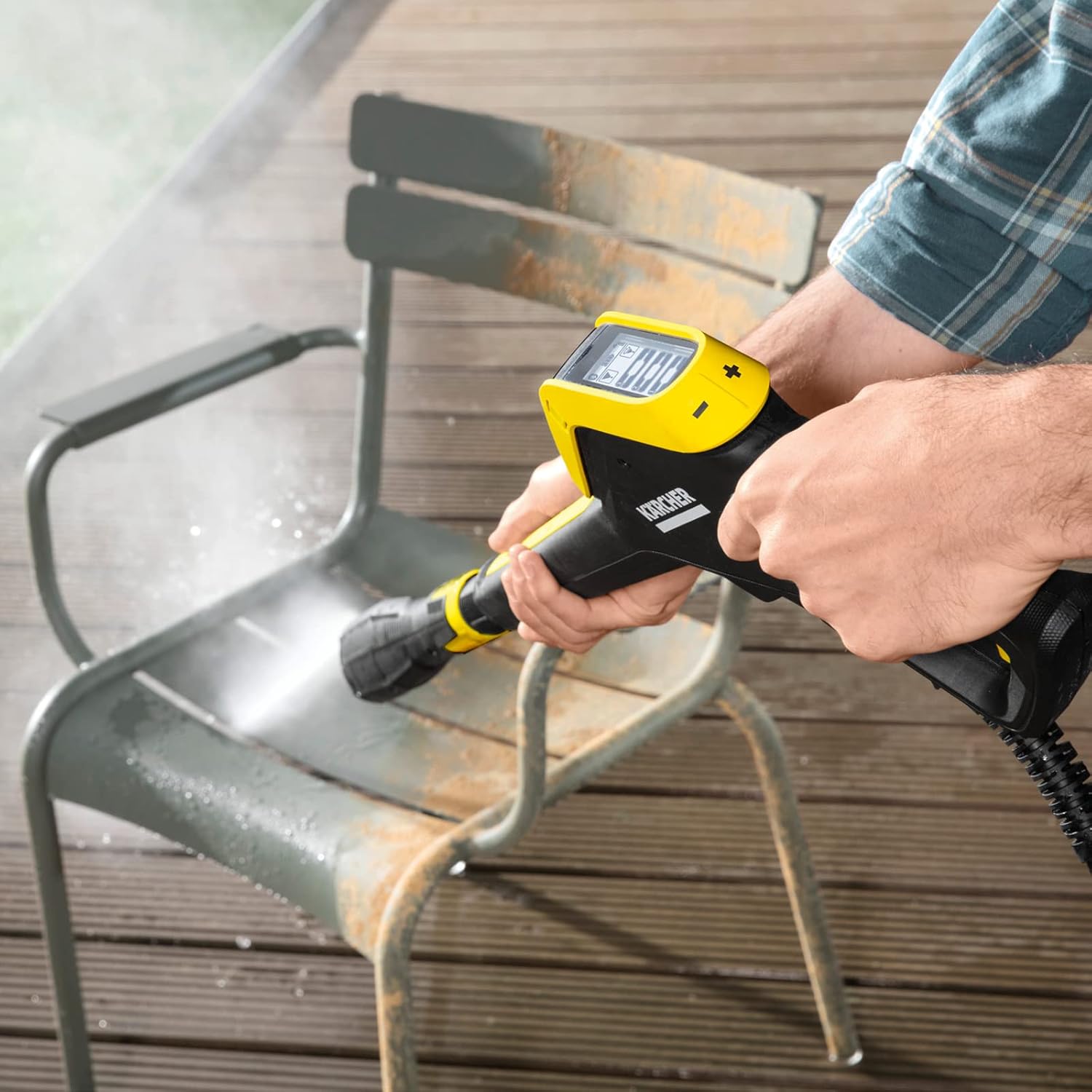 Person cleaning a chair with Kärcher K5 pressure washer