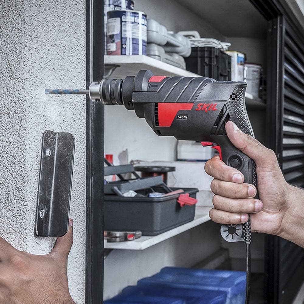 Person using Skil 6604 Impact Drill to drill into a wall