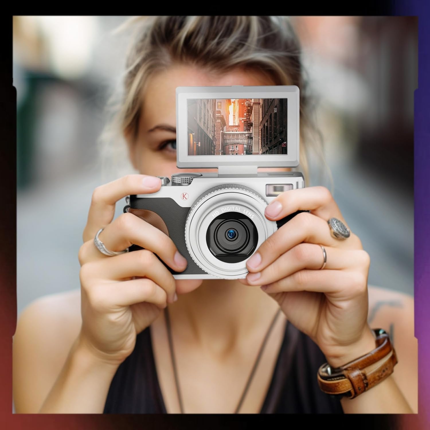 Person holding NBD K100 camera with flip-out screen