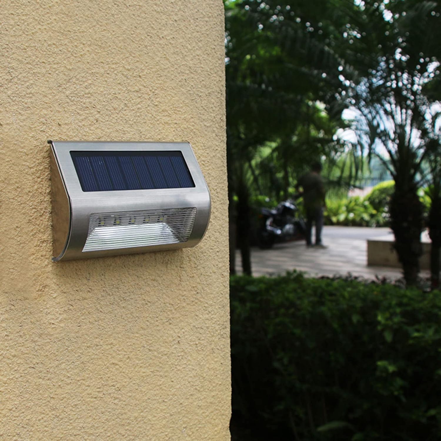 Solar flood light mounted on a wall