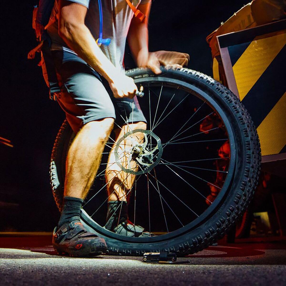Person inflating a bicycle tire with a CO2 inflator