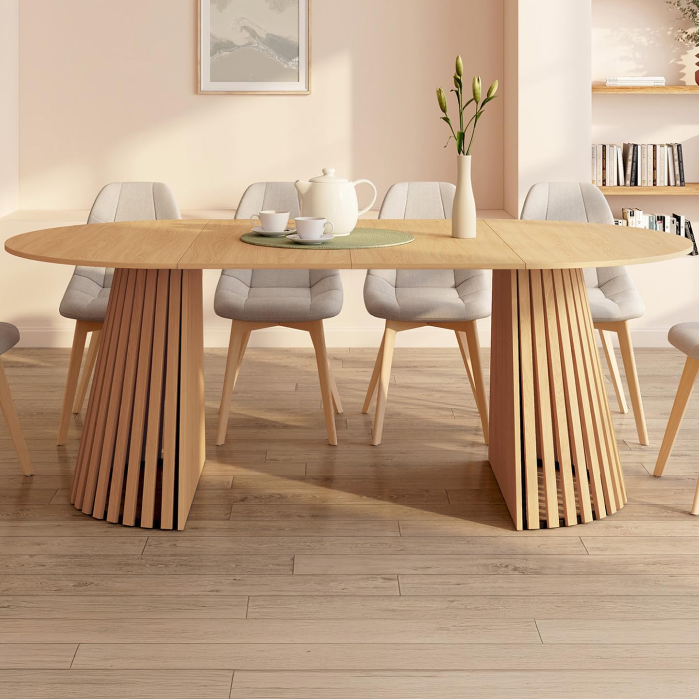 IDMarket CARMEN dining table in its extended oval configuration, set up for a meal in a dining room.