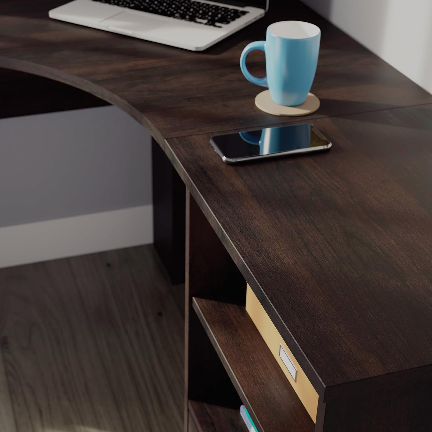 Close-up of the desk surface with a phone and mug