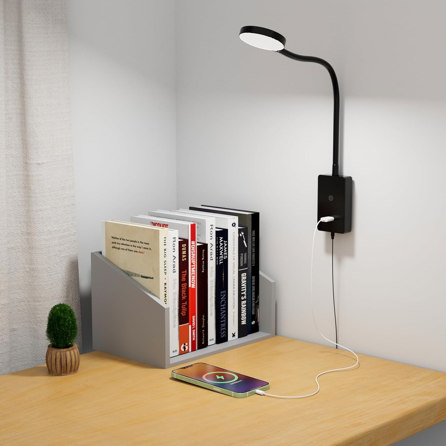 ENUOTEK LED reading light installed above a desk, illuminating books and a charging smartphone.