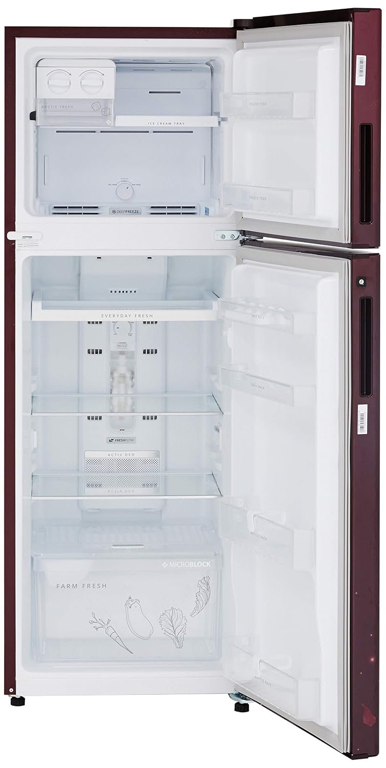Interior of the refrigerator with toughened glass shelves and various food items