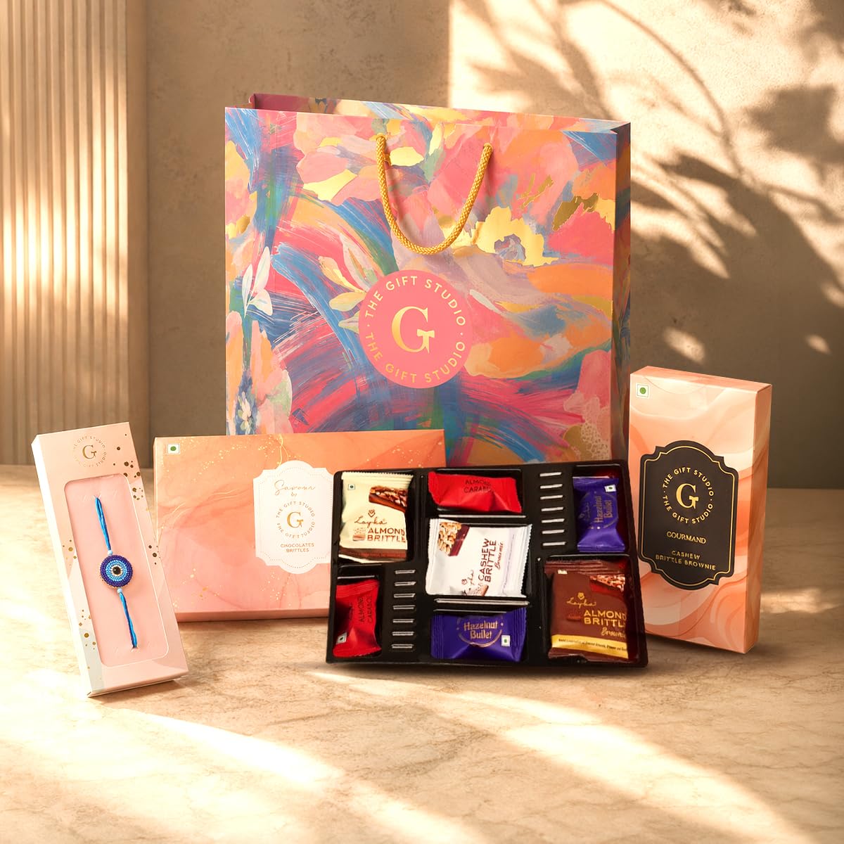 THE GIFT STUDIO.COM | Celebration Rakhi Gift Hamper for Brother | Beaded Evil Eye Rakhi, Premium Assorted Chocolates Box & Cashew Brittle | Raksha Bandhan Gift-image-39