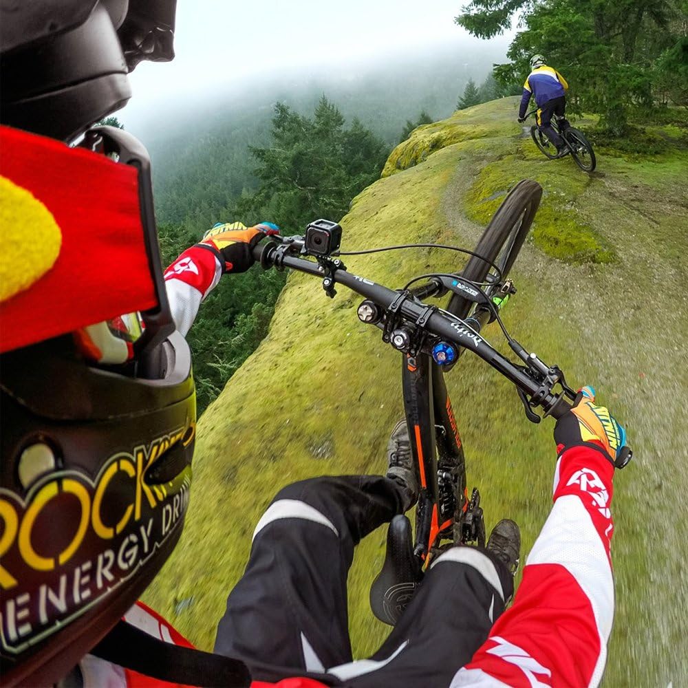 GoPro camera mounted on a bicycle handlebar, capturing a first-person view of a rider on a trail.