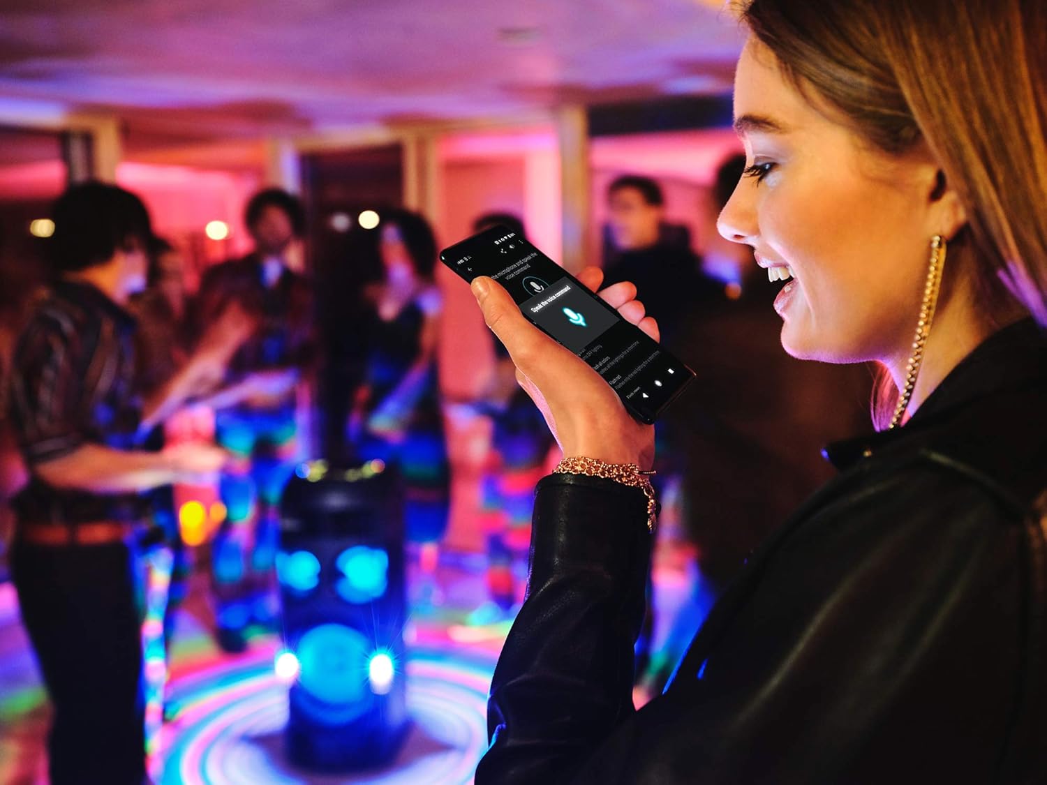 Person using a smartphone with Fiestable app for voice control of the speaker