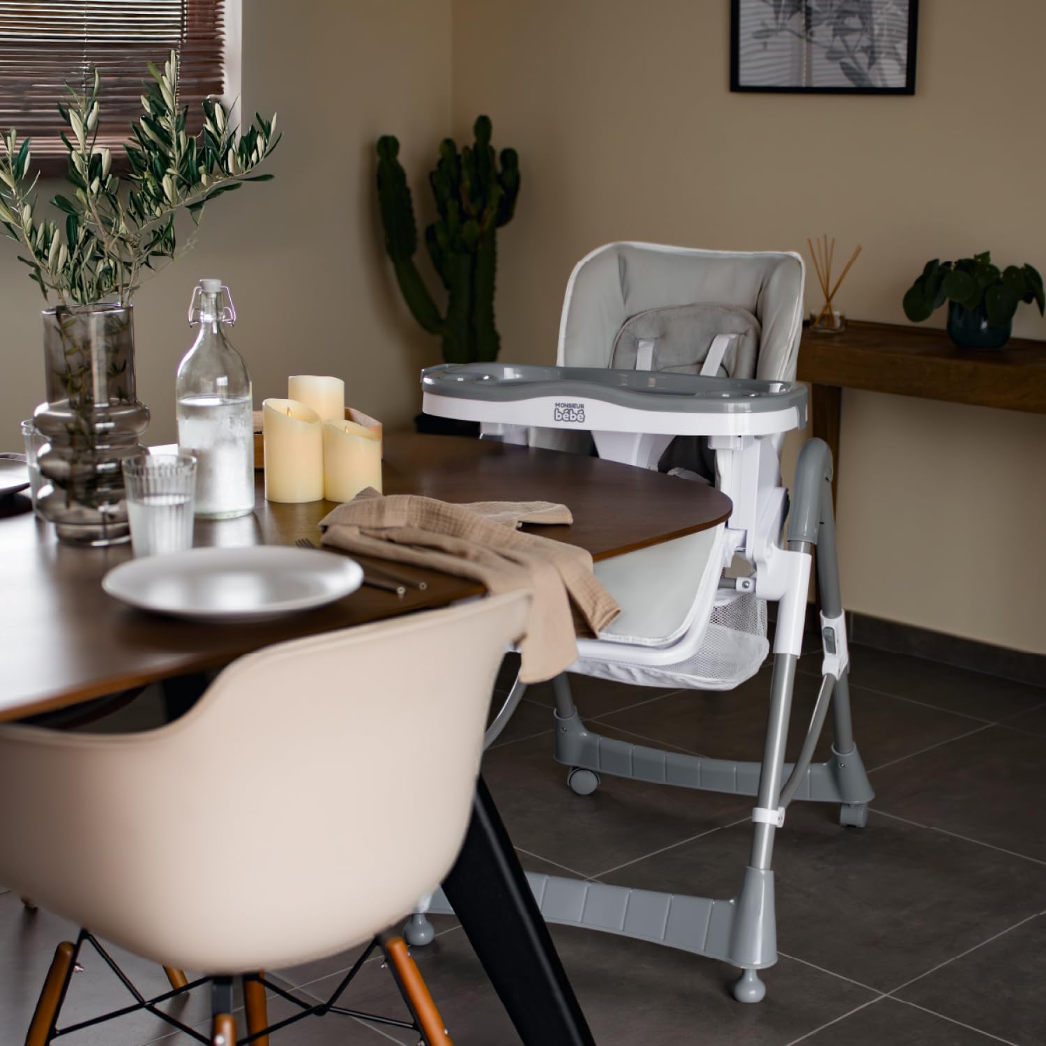 A child in the high chair positioned at a dining table, demonstrating its use.