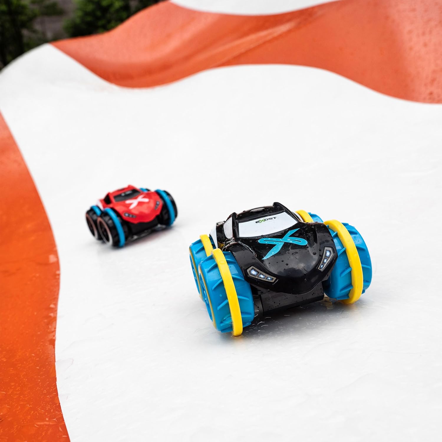 Two EXOST Aquacyclone XS cars on a water slide