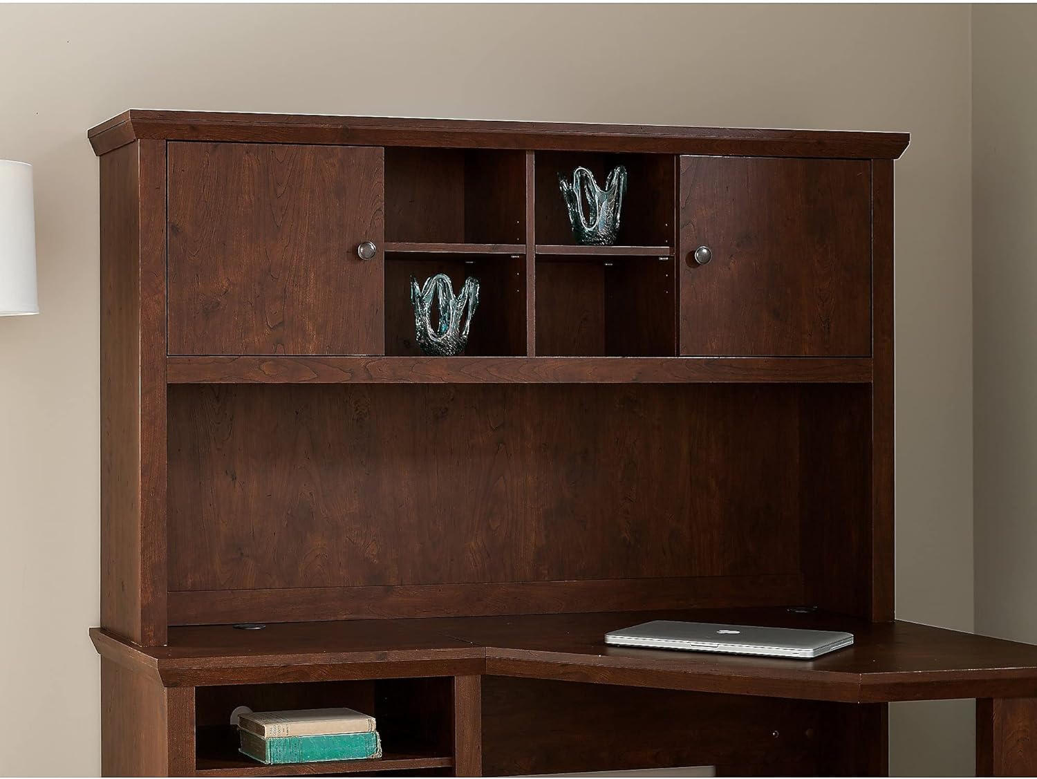 The Bush Furniture Yorktown 60W Desk Hutch in antique cherry, showing two closed cabinet doors and open cubbies in the center, with decorative items inside.