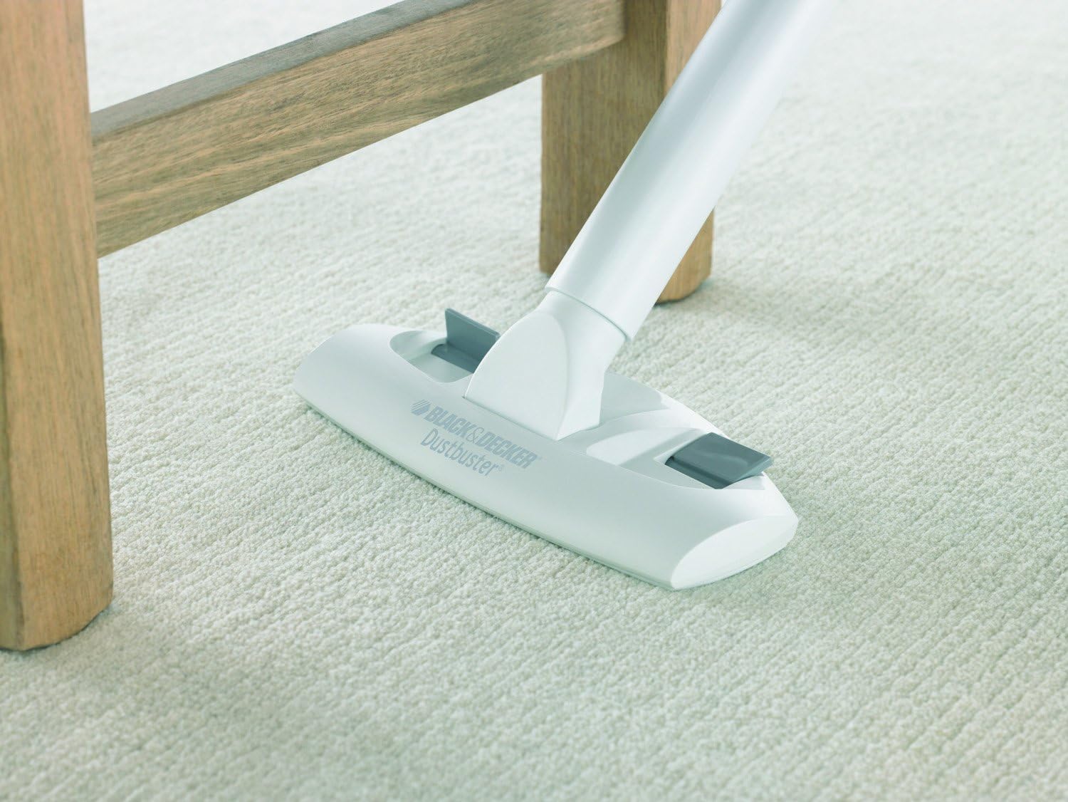 Woman using Dustbuster with floor attachment