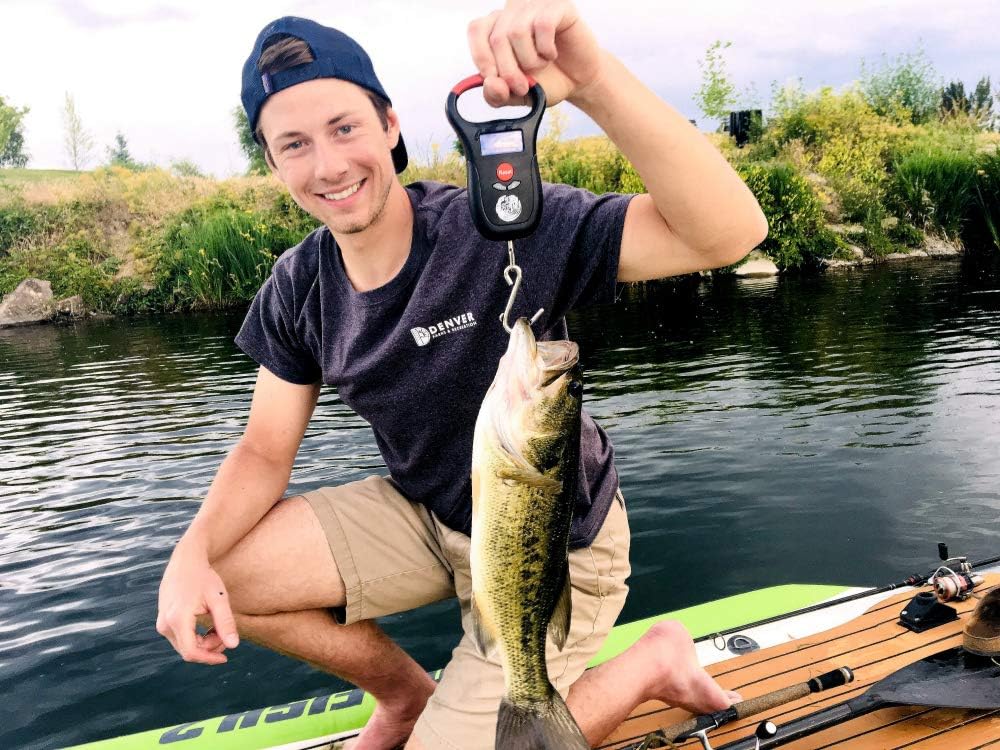 Man holding a fish with the Kraken Bass Fishing Scale