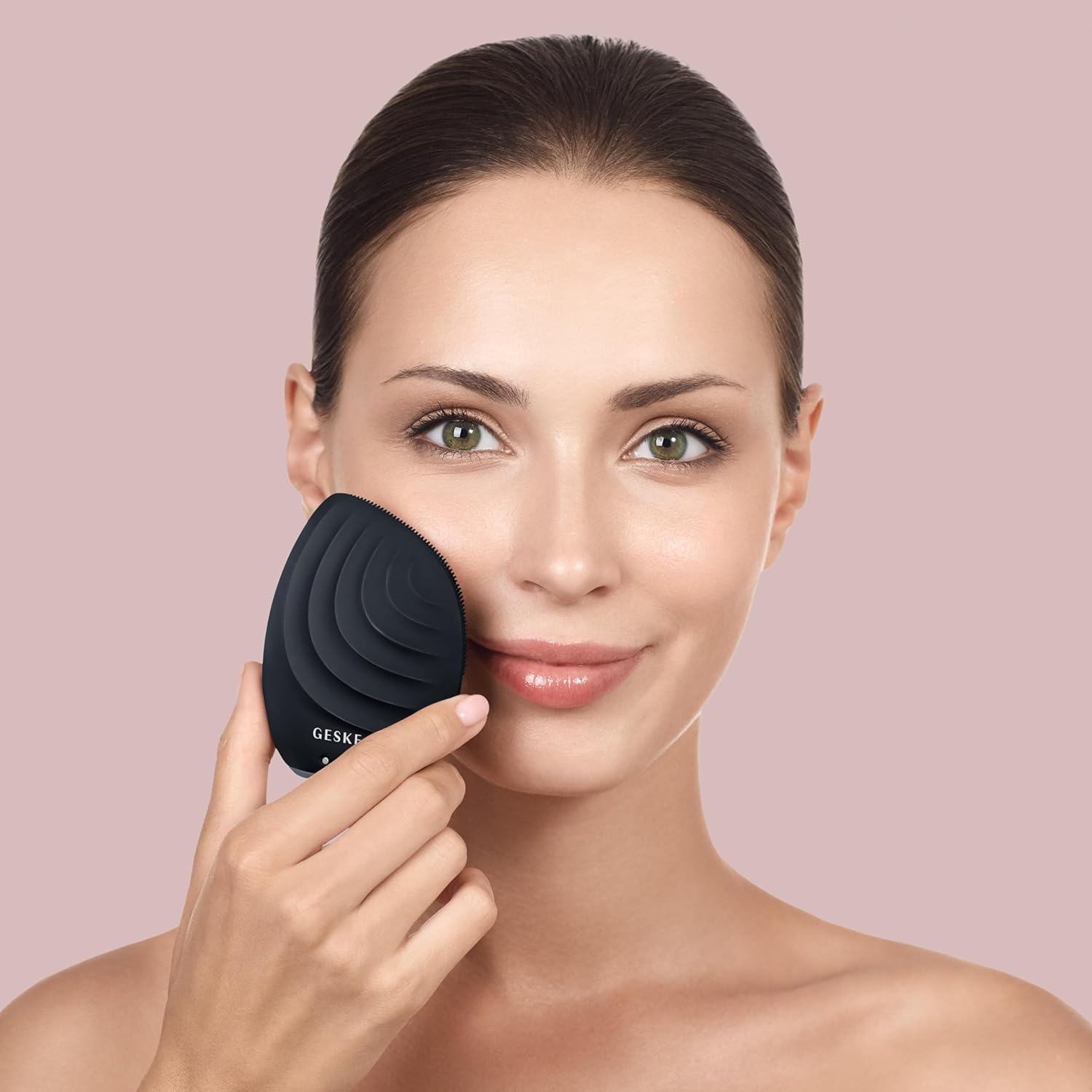 Woman using GESKE Sonic Facial Brush for cleansing