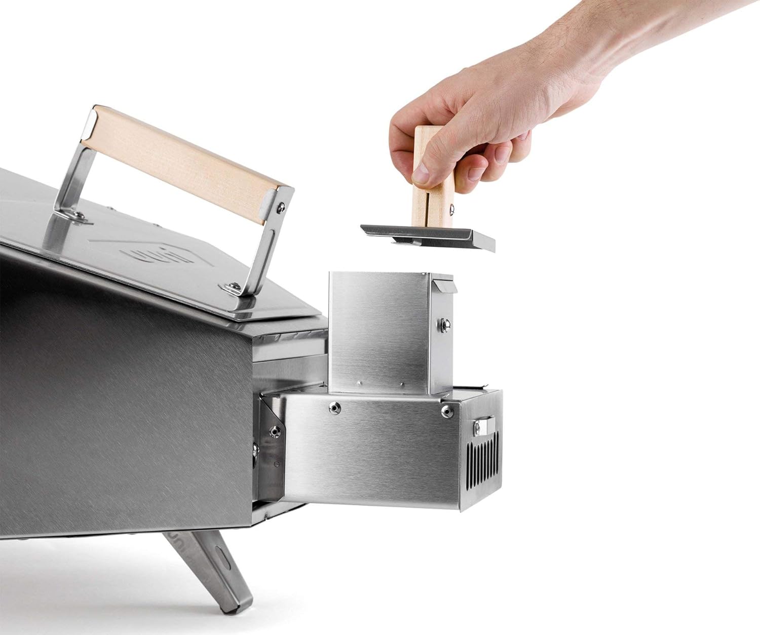 Hand inserting the pellet hopper lid into the Ooni Pro Pellet Burner