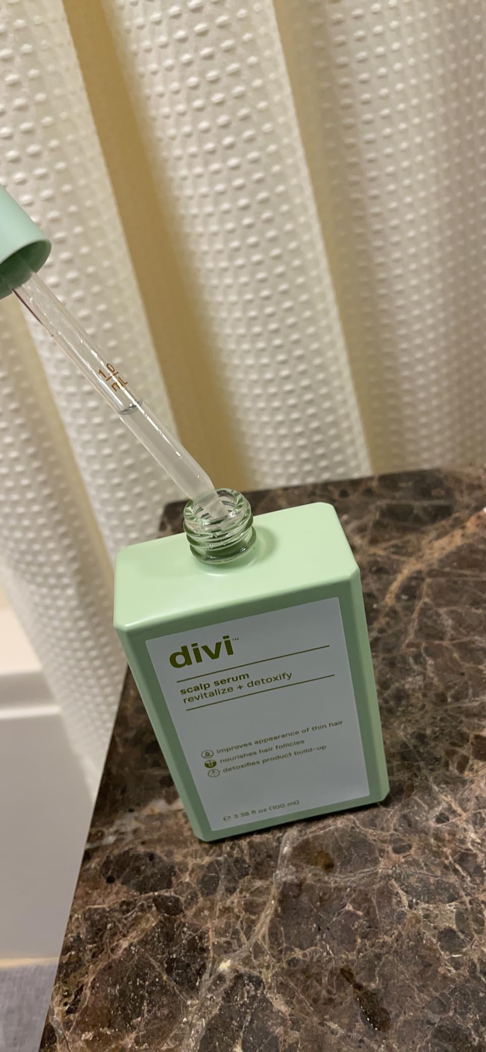 Shelfie of Divi Scalp Serum with hair tools