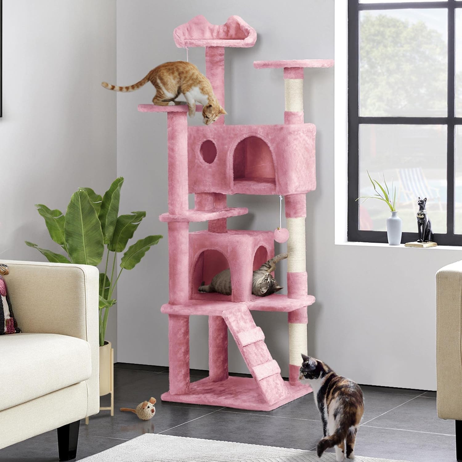 Pink cat tree placed in a living room setting with cats enjoying it.
