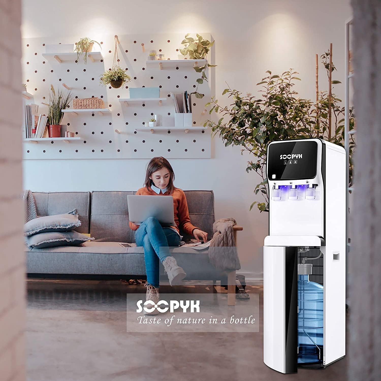 Podrobno view of the SOOPYK water cooler's control panel and three dispensing spouts for hot, room, and cold water.