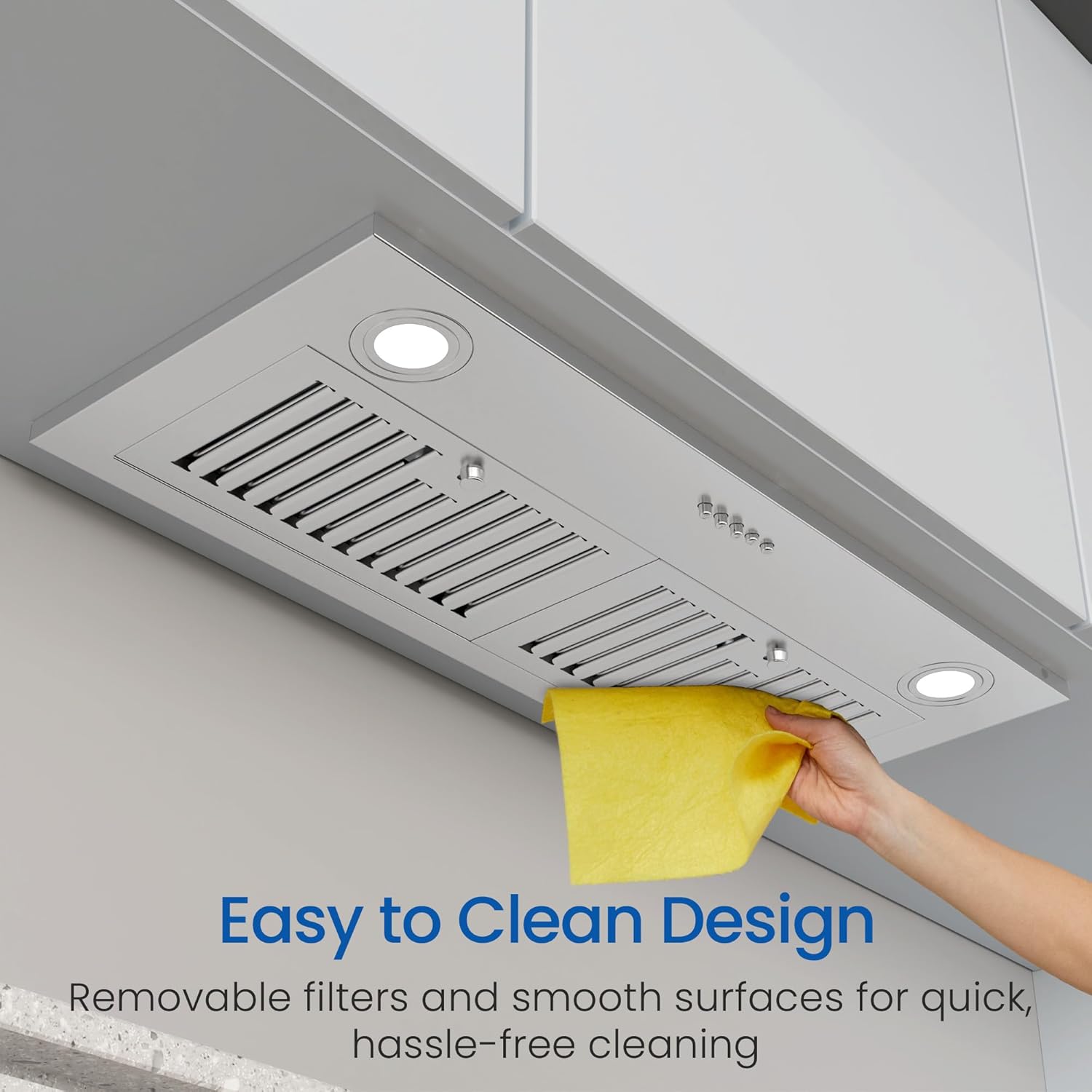 Hand wiping the smooth surface of the range hood with a yellow cloth