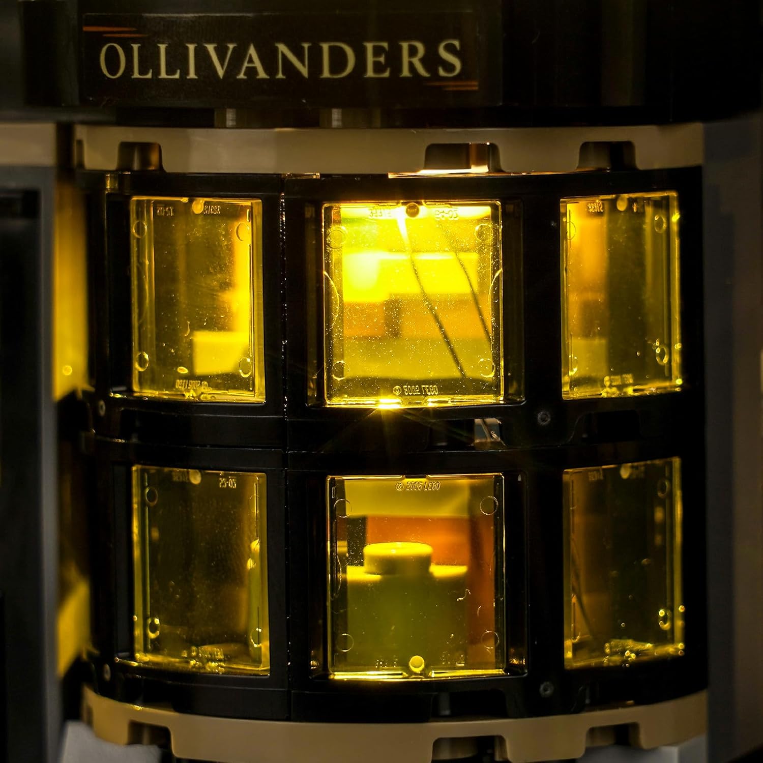 Close-up of the Ollivanders section of the LEGO set illuminated by the Hilighting LED Light Kit, showing warm yellow light through the windows.