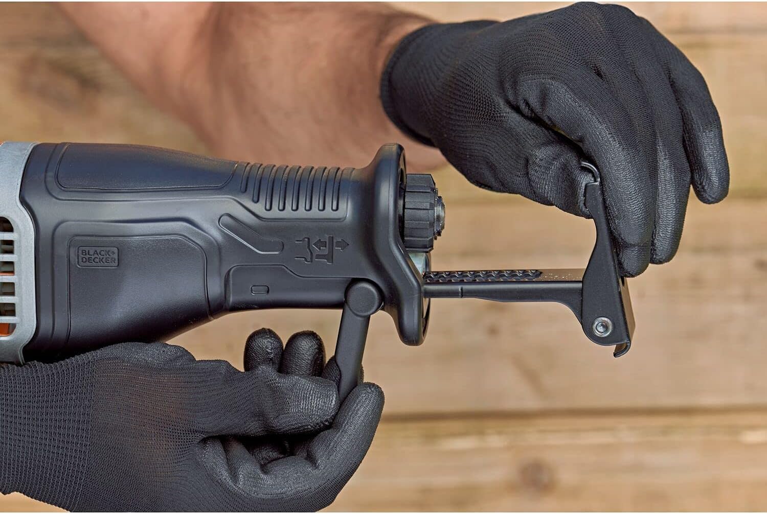 Hands removing a saw blade from the tool-free blade clamp of the reciprocating saw.